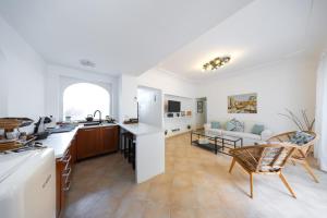 a kitchen and living room with a table and chairs at Birago22Capri in Capri