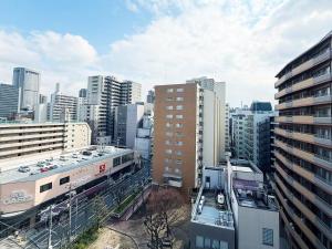 a view of a city with buildings and a train at サムティ扇町 in Osaka