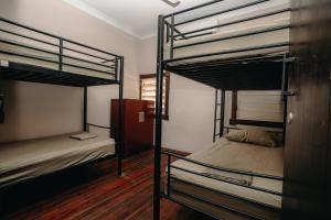 a room with two bunk beds in a room at Kimberley Travellers Lodge in Broome