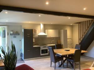 a kitchen and dining room with a table and chairs at Au duplex in Chantonnay