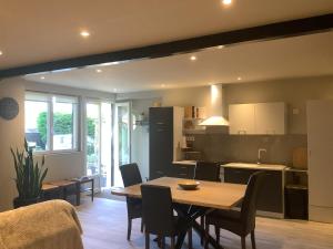 a kitchen and dining room with a table and chairs at Au duplex in Chantonnay