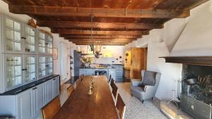a kitchen with a long wooden table in a room at Casa borgo Arias Lake View in Tremosine Sul Garda