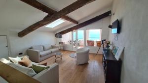 a living room with two couches and a tv at Casa borgo Arias Lake View in Tremosine Sul Garda