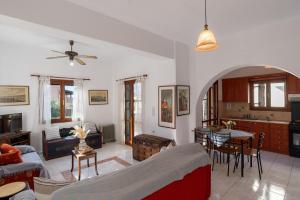 a living room with a couch and a table at Arto's Villa With Private Pool- BY APOKORONAS VILLAS in Plaka