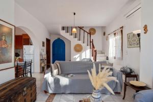 a living room with a couch and a table at Arto's Villa With Private Pool- BY APOKORONAS VILLAS in Plaka