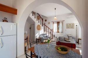 a living room with a table with a bowl of fruit at Arto's Villa With Private Pool- BY APOKORONAS VILLAS in Plaka +37 photos
