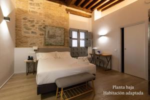 a bedroom with a large bed in a room at Posada Sillería - Historic boutique Hotel in Toledo