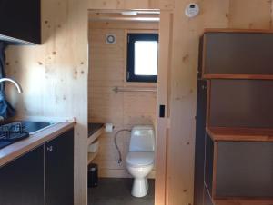 a small bathroom with a toilet and a sink at Casa do Cipreste by Tiny Away in São Teotónio