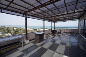 a balcony of a building with a view of the ocean at v square inn in Visakhapatnam