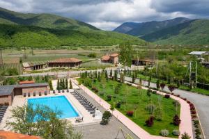 an aerial view of a resort with a swimming pool and mountains at Chateau Artwine in Art'ana