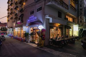 a building with a store on the side of a street at Sweet Lavender Hotel - Ngay chợ đêm Đà Lạt in Da Lat