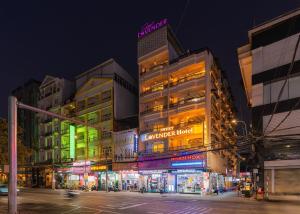 a building with neon lights in a city at night at Sweet Lavender Hotel - Ngay chợ đêm Đà Lạt in Da Lat