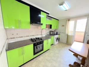 a kitchen with lime green cabinets and a stove at 1 Double Budget Room Center Park in Chişinău