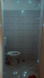 a bathroom with a toilet in a shower stall at Leisure guest in Diani Beach