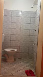a bathroom with a toilet and a shower stall at Leisure guest in Diani Beach