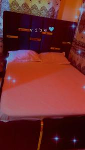 a bedroom with two beds with lights on them at Leisure guest in Diani Beach