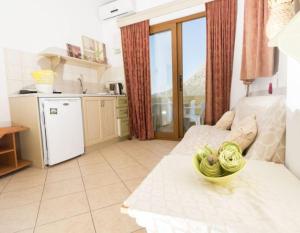a kitchen and a living room with a kitchenasteryasteryasteryasteryasteryasteryastery at Dimitrakis Studios in Masouri