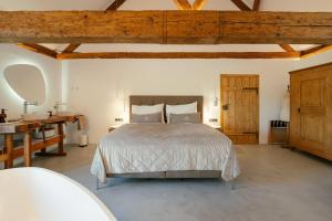 a bedroom with a bed and a desk and a sink at Chalet Weidehaus De Luxe in Obertriesting
