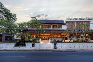 a house on the side of the street at Anumana Ubud Hotel in Ubud