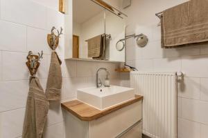 a bathroom with a white sink and a mirror at Haus Kali in Teisendorf +27 photos