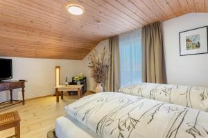 a hotel room with two beds and a flat screen tv at Haus Kali in Teisendorf