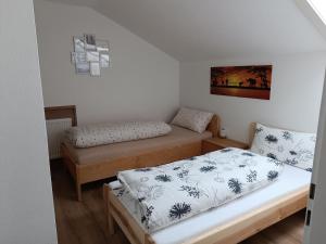 a small room with two beds and a bedskirts at Haus Kali in Teisendorf