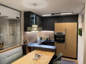 a kitchen with a table and a sink and a counter at Tauplitzrausch Lodge in Tauplitz