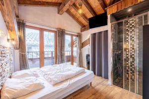 a bedroom with a bed and a large window at Chalet Bordon in Champagny-en-Vanoise