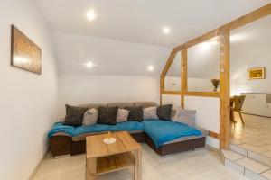 a living room with a couch and a table at Ferienwohnung Sonnenblume in Rhadern
