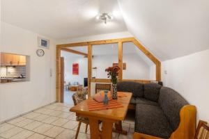 a living room with a couch and a table at Ferienwohnung Sonnenblume in Rhadern +16 photos