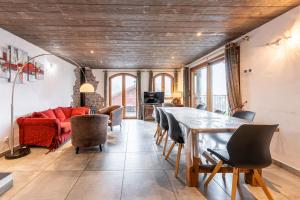 a living room with a red couch and a table at Chalet Bordon in Champagny-en-Vanoise