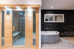 a bathroom with a tub and a walk in shower at Chalet Bordon in Champagny-en-Vanoise +45 photos
