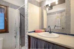 a bathroom with a sink and a shower at Casa Azul - Vejer, El Palmar in Vejer de la Frontera