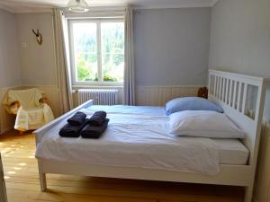 a bedroom with a white bed with two towels on it at Fewo Moonshine 79 in St. Blasien