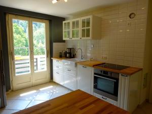 a kitchen with white cabinets and a stove top oven at Fewo Moonshine 79 in St. Blasien