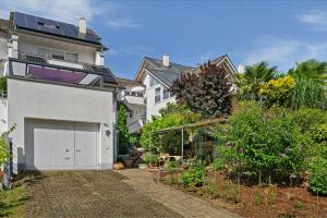 a white house with a garage in front of it at Casa Bianca in Offenburg