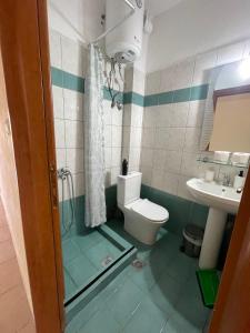 a bathroom with a toilet and a sink at Almond Apartments in Orfánion +17 photos