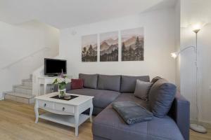 a living room with a couch and a table at Casa Bianca in Offenburg
