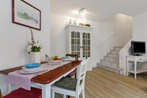 a dining room with a table and a tv at Casa Bianca in Offenburg