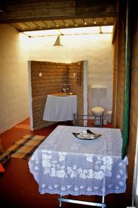 a room with a table with a table cloth on it at FARINHA DE PAU - ECO B&B in Tarrafal +129 photos