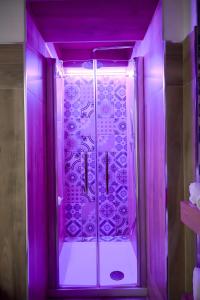 a bathroom with a shower with purple lighting at Orchidea Celeste Bed and Breakfast in Manfredonia +71 photos