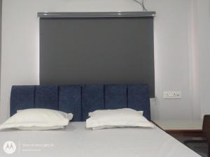 a bed with two pillows on top of it at Chouhan Resort in Katihār
