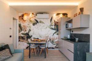 a kitchen with a table and a wall mural at Cà di Cambret with lake View in Stresa