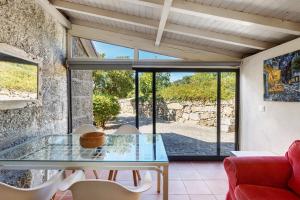a dining room with a glass table and chairs at Casa de Andrães Camélias in Marco de Canaveses