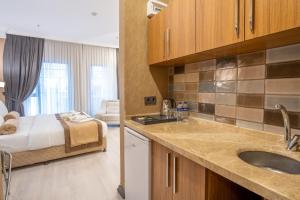 a kitchen with a sink and a bed in a room at Orange Hotel & Spa in Şişli +21 photos