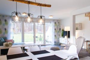 a dining room and living room with a table and chairs at Lieblingsinsel in Graal-Müritz