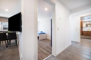 a living room with a television and a dining room at Ferienwohnung Leuchtturm in Osterbruch