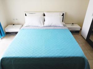 a bed in a room with two night stands at Almond Apartments in Orfánion