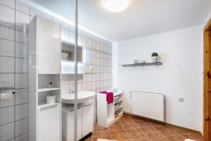 a white bathroom with a sink and a toilet at Ferienhaus Himmelreich in Barlt +23 photos