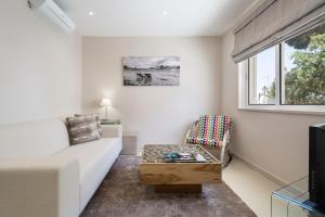 a living room with a couch and a coffee table at Villa Leeroy in Almancil